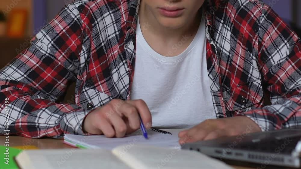 High school student preparing to exams at night, hardly studying, close up High school student preparing to exams at night, hardly studying, close up