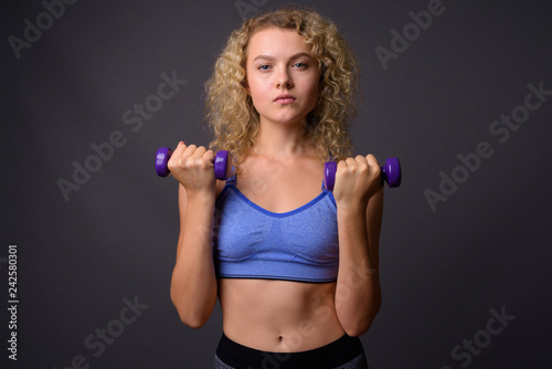 Young beautiful sport woman ready for gym holding dumbbells