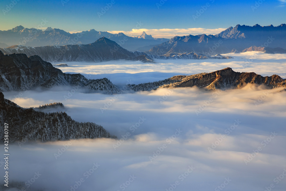 Dawn, Sunrise above the clouds - Niubeishan Landscape, Cattle Back Mountain, Sichuan Province China. Snow mountains, Ice Frost and Rime. Frozen Winter Landscape, Frigid Cold Atmosphere. Sea of Clouds