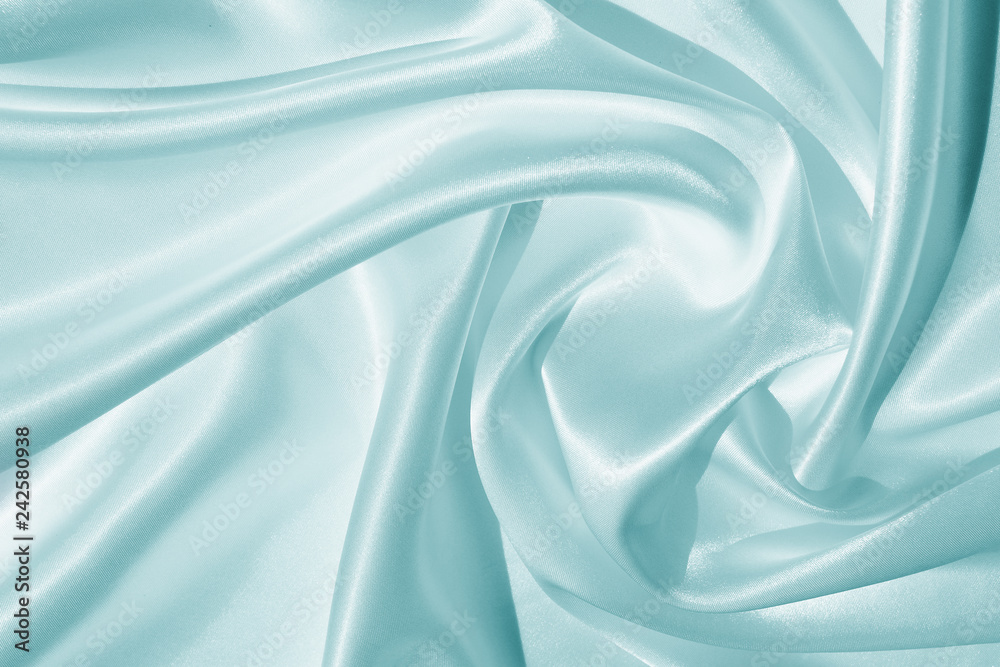 The texture of the satin fabric of blue color for the background The texture of the satin fabric of blue color for the background