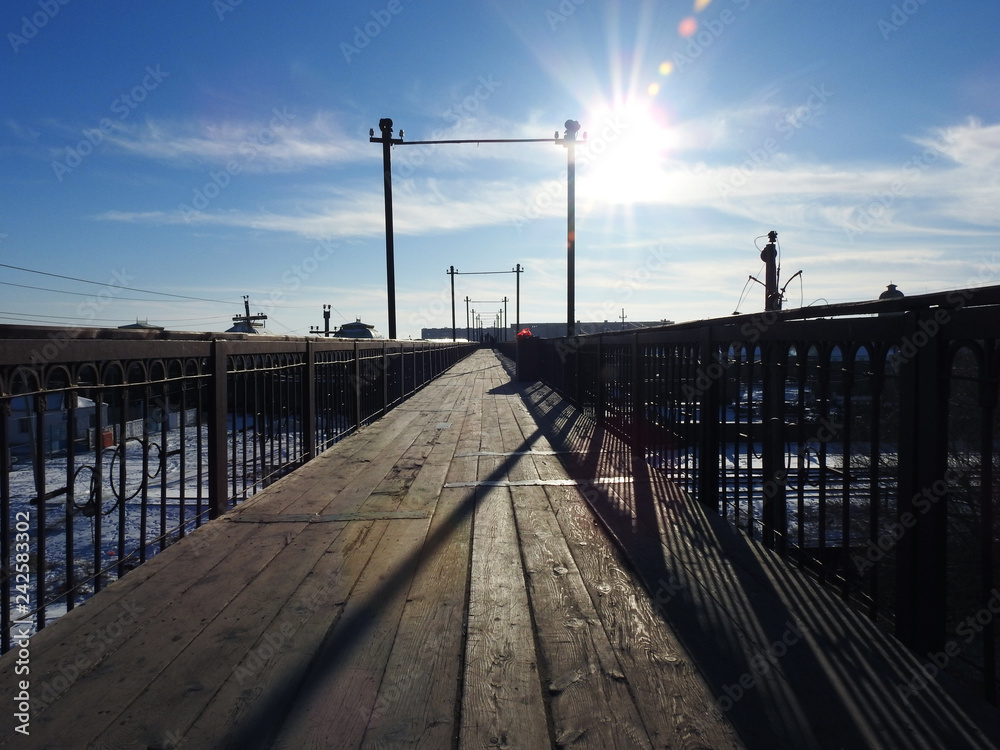 OLD WOODEN BRIDGE IN RAILWAY STATIONS, BLACK IRON AND BLUE SKY