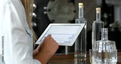 Female worker using digital tablet in distillery factory 4k photo