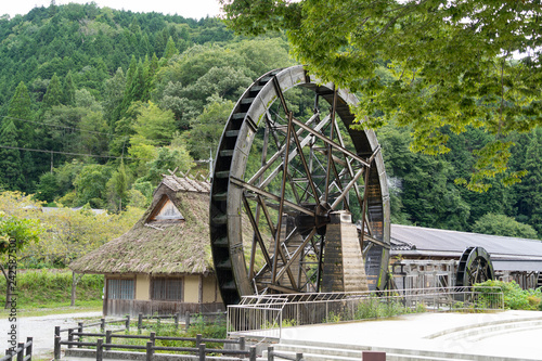 Water mill is at the side of the hut in Japan.