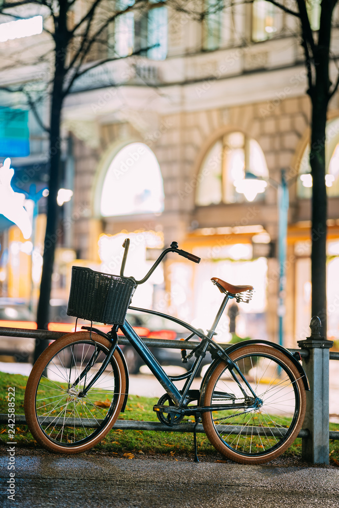 Fototapeta premium Bicycle Equipped Basket Parked In European City Street In Night 