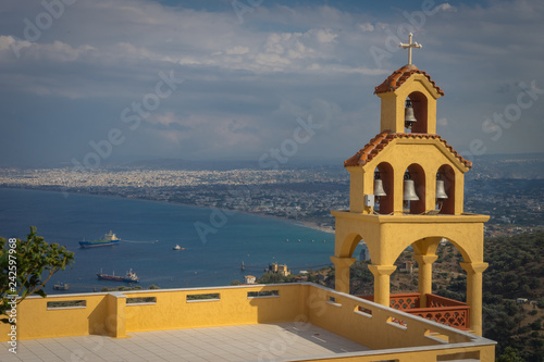 Heraklion, Crete - 10 01 2018: On the road to Rodia. A yellow church with bells photo