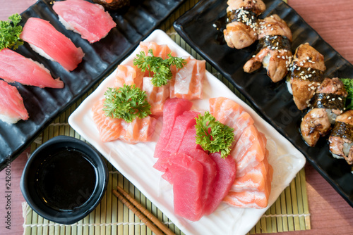 Mixed sliced fish sashimi in white plate. Sashimi Salmon and Tuna set with Tuna, flying fish roe caviar and Foie Gras closeup. Japan restaurant menu