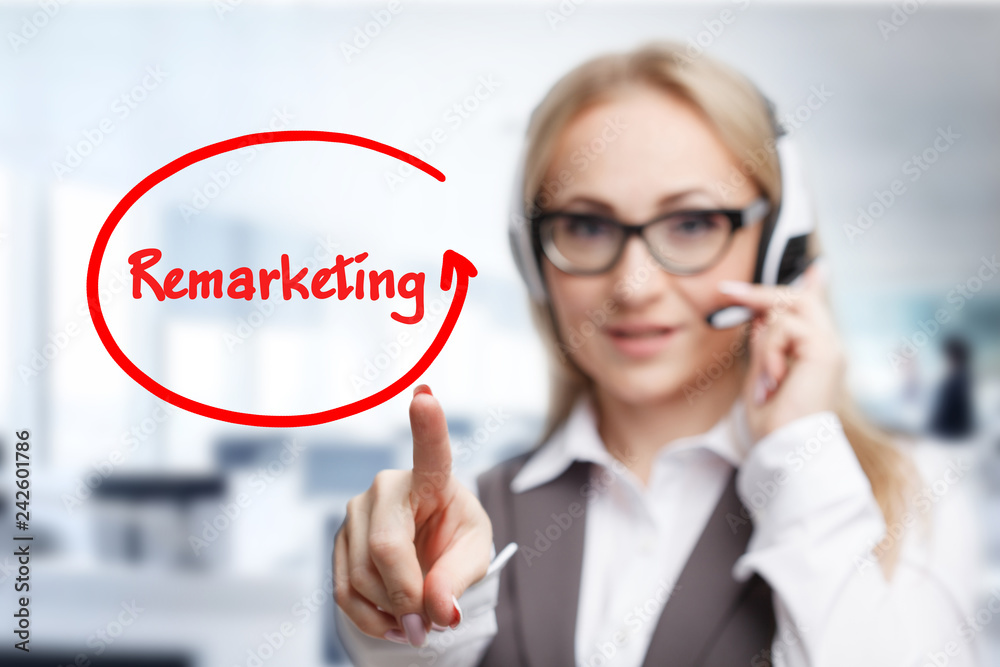 Technology, internet, business and marketing. Young business woman writing word: Remarketing Technology, internet, business and marketing. Young business woman writing word: Remarketing