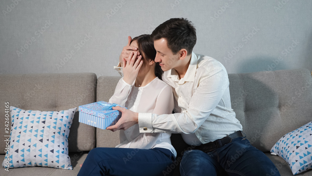 man closes his is girlfriend's eyes to make surprise man closes his is girlfriend's eyes to make surprise