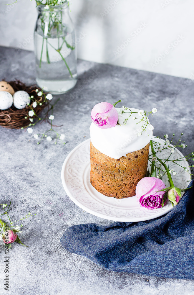 Easter cake kulich. Traditional Easter sweet bread decorated meringue and pink roses on plate on gray stone table background. Copy space. Easter cake kulich. Traditional Easter sweet bread decorated meringue and pink roses on plate on gray stone table background. Copy space.