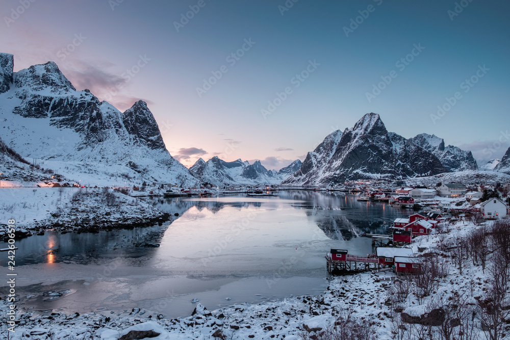 Viewpoint of fishing village with harbor in snow valley and ice sea at morning