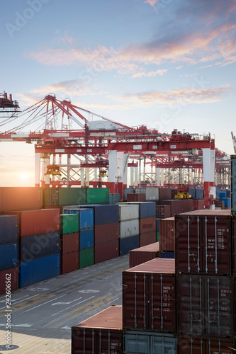 Logistics and transportation of Container Cargo ship and Cargo plane with working crane bridge in shipyard, logistic import export and transport industry background