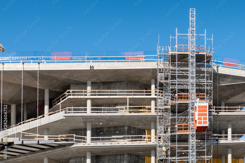 Worker working on structure of scaffolding Worker working on structure of scaffolding