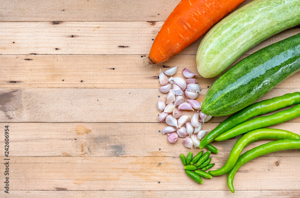 Carrot, Cucumber, Pepper Chili, Garlic on wooden table Carrot, Cucumber, Pepper Chili, Garlic on wooden table