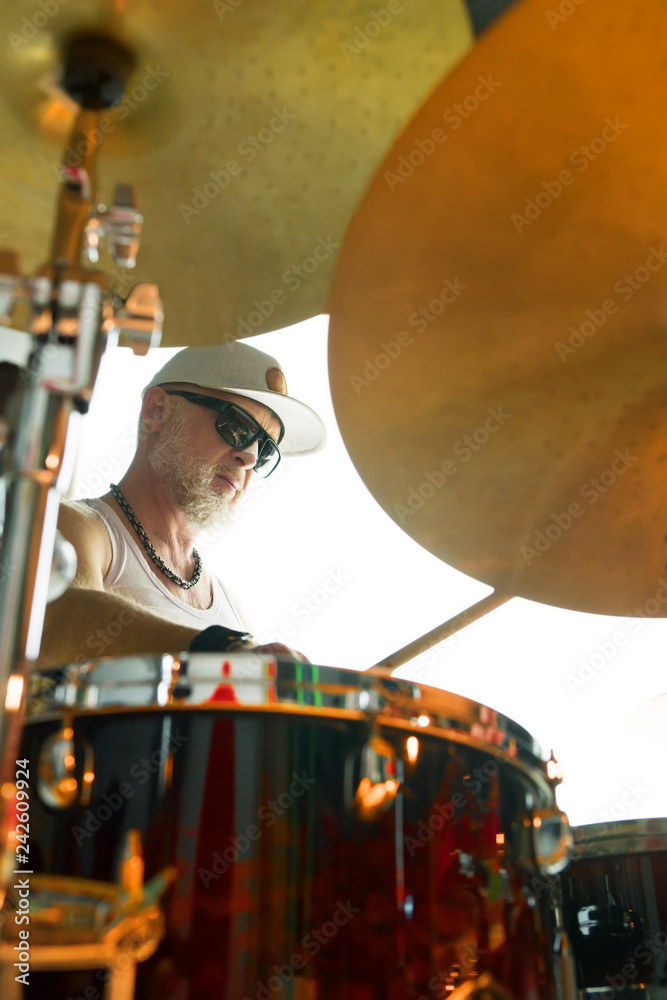 Obraz premium Drummer plays musical percussion instrument with drumsticks