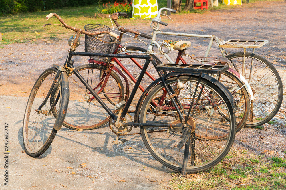 Old and rusty bicycles are on display at the roadside as part of decoration objects in the park, selective focus and copy space.