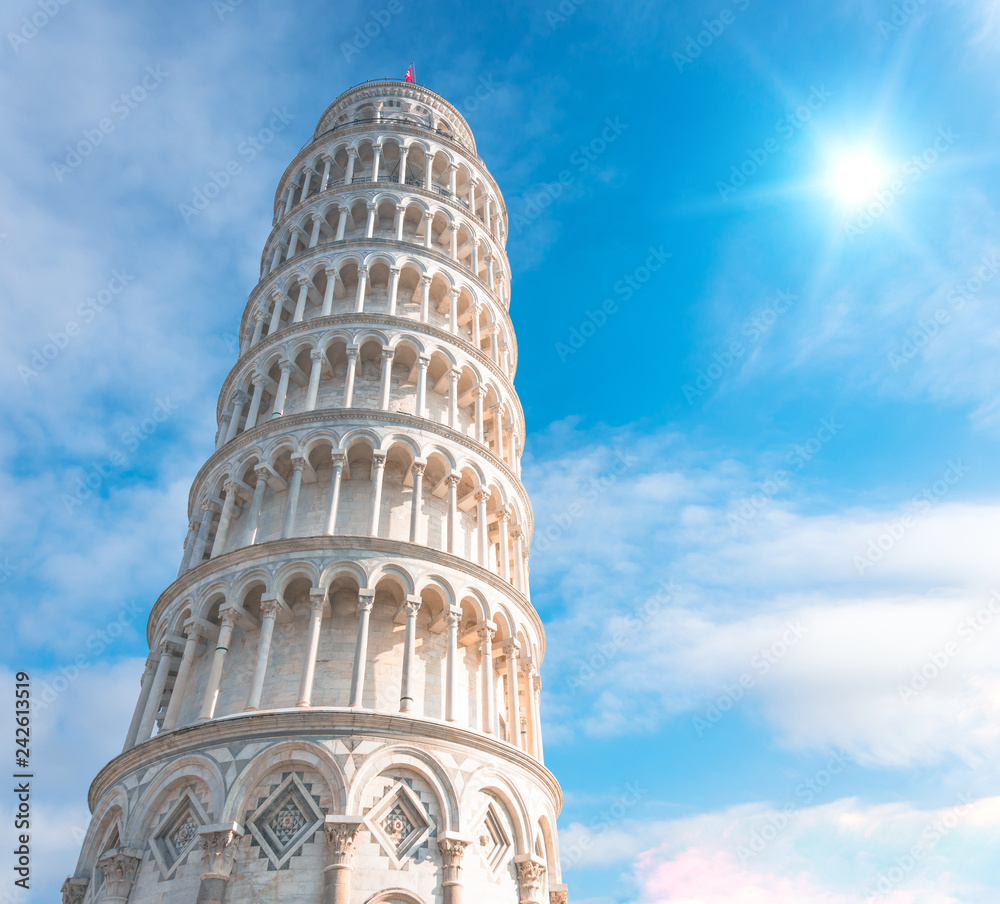 The Leaning Tower of Pisa, Italy, against the background of a beautiful day sky and the bright sun