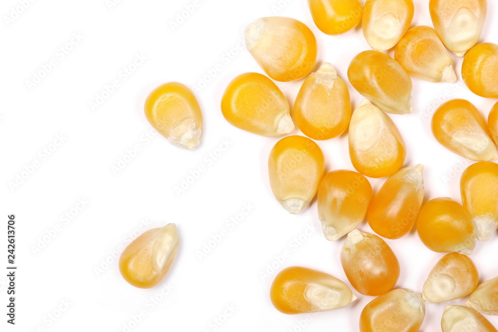 Yellow raw corn kernels isolated on white background, macro, top view Yellow raw corn kernels isolated on white background, macro, top view