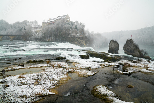 Rhine Falls in Switzerland on a winter day with snow falling