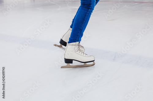 Skates on the rink. Woman on the ice