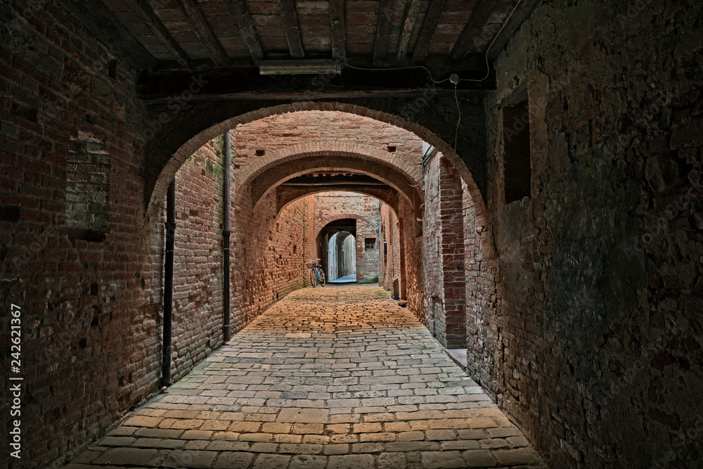 Buonconvento, Siena, Tuscany, Italy : the covered street Via Oscura in the old town