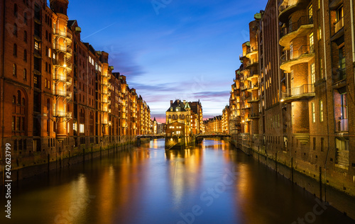 Hamburg Speicherstadt (warehouse district) in the evening, colorful with Watercastle (Wasserschloss)