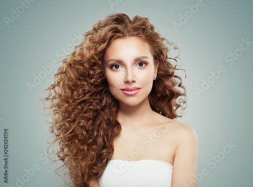 Young beautiful model woman with long healthy hairstyle on gray background