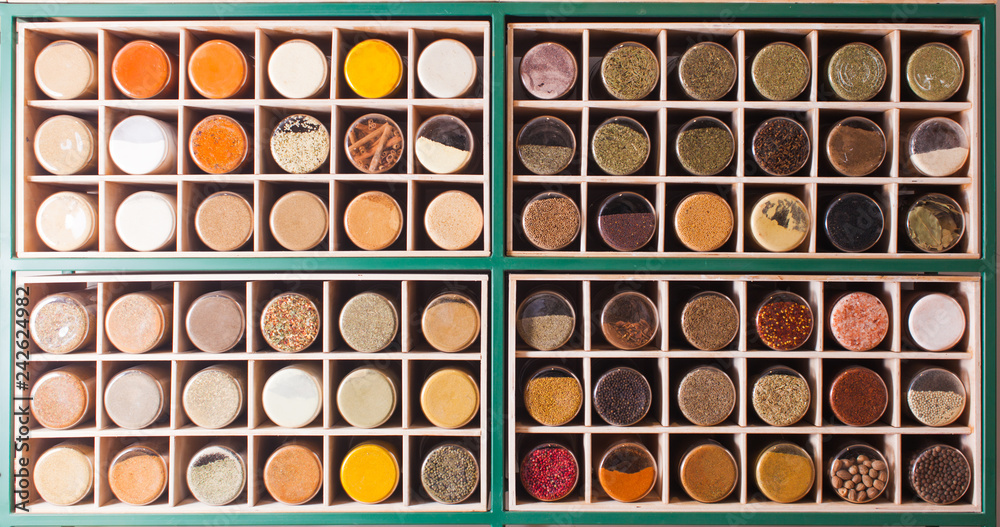 Spices in glass jars located in cubic cells Spices in glass jars located in cubic cells