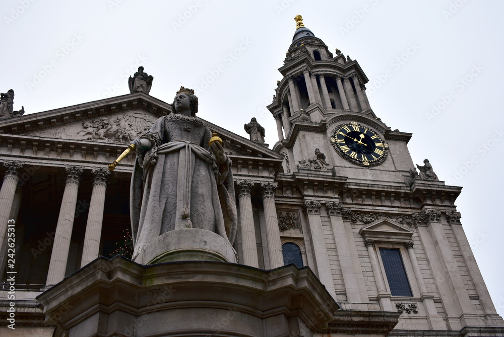 St Pauls Cathedral. Facade closeup with Queen Anne statue and tower with golden clock. London, United Kingdom, Christmas.