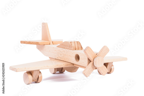 Photo of a wooden plane  of beech. Toy made of wood retro aircraft on a white isolated background © Виталий Сова