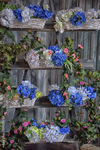 Fototapeta Naklejka Na Ścianę i Meble -  white and blue flowers in wicker baskets