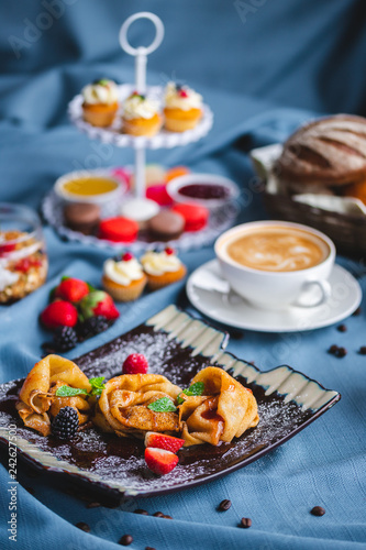 breakfast with coffee, cereal, croissant, yogurt, bread, biscuits