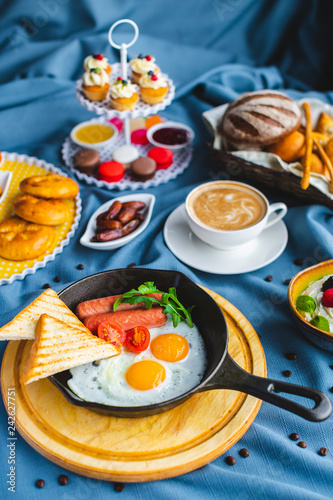 poached egg  breakfast with coffee and scrambled eggs and toast in a pan