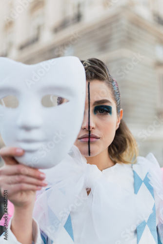 Street performer with white mask