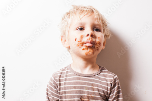 Boy eated chocolate, funny dirty smiled face