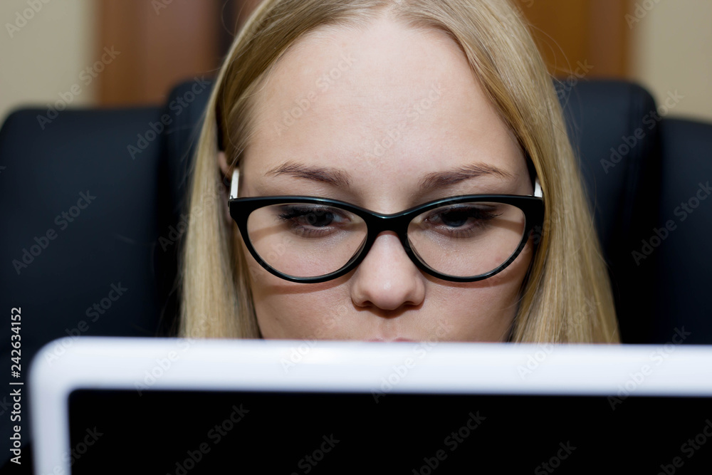A girl holds in her hands and uses a tablet computer close up. A girl holds in her hands and uses a tablet computer close up.
