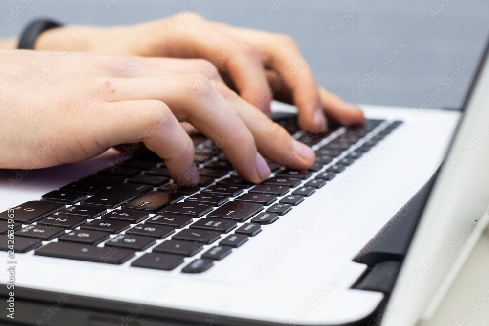 Man using laptop, searching web, browsing information, having workplace at home Man using laptop, searching web, browsing information, having workplace at home