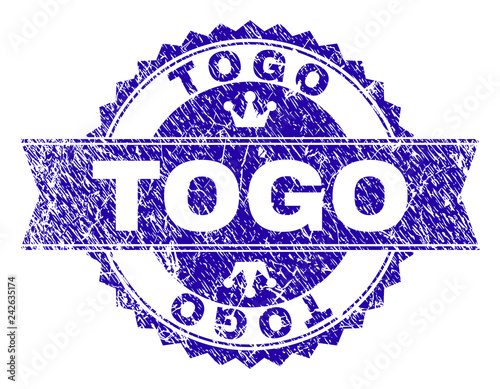 TOGO rosette stamp seal watermark with grunge texture. Designed with round rosette, ribbon and small crowns. Blue vector rubber watermark of TOGO tag with dust texture.