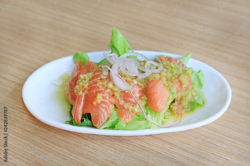 Japanese food, Spicy salmon salad on wooden table. Japanese food, Spicy salmon salad on wooden table.