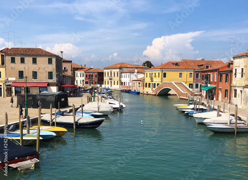 Sunny summer day in Murano  Venice  Italy  boats and colorful houses around. Venice panorama view 