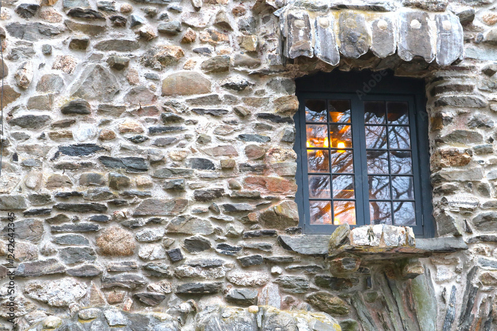 Old glass pane window on historic  stone castle building