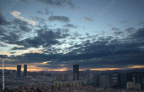 Urban real estate concept: city on twilight color sky and clouds cityscape background photo