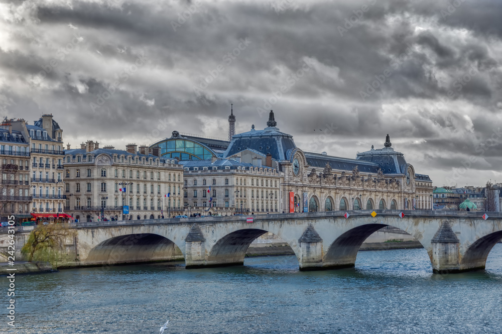 Pont royal and Musee d'Orsay with Eiffel tower in backgroung in winter under a heavy sky - Paris, France. Pont royal and Musee d'Orsay with Eiffel tower in backgroung in winter under a heavy sky - Paris, France.