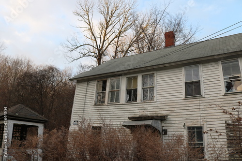 Old abandoned wooden weathered abandoned New England farmhouse 