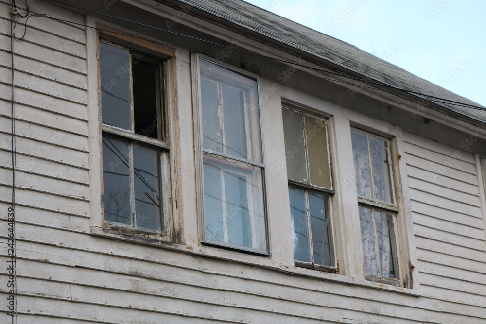 Old abandoned wooden weathered abandoned New England farmhouse 