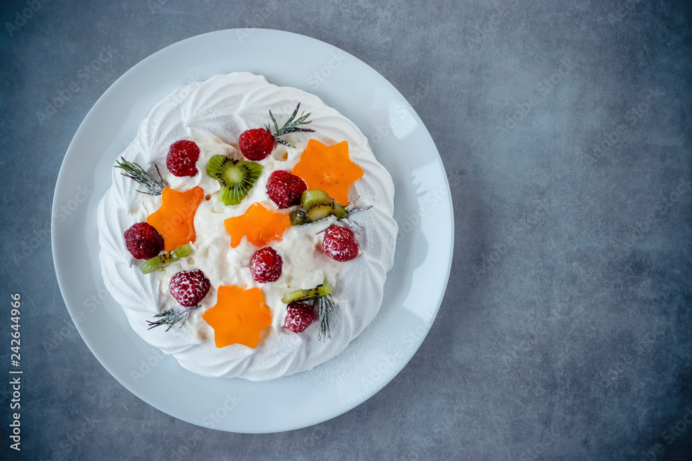 Dessert Pavlova. Cake with whipped cream and fresh berries.