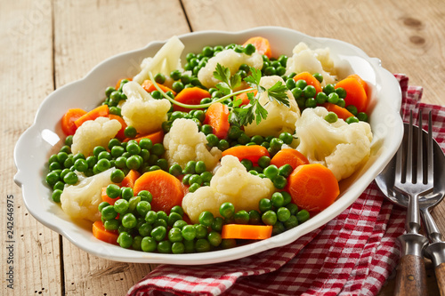 White dish of fresh steamed mixed vegetables