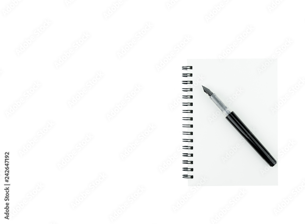 Ink pen on note book with copy space on isolated white background Ink pen on note book with copy space on isolated white background