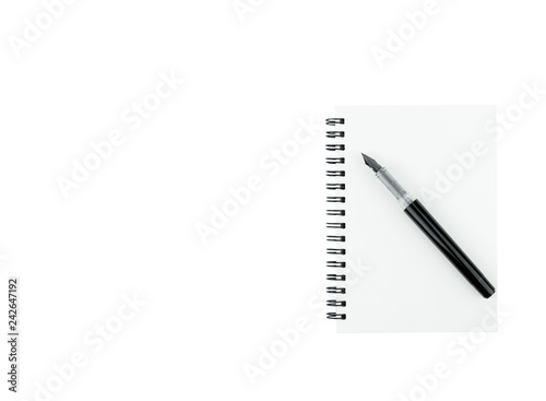 Ink pen on note book with copy space on isolated white background