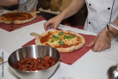 Pizza Maker who Prepares a Delicious Margherita Pizza with Basil
