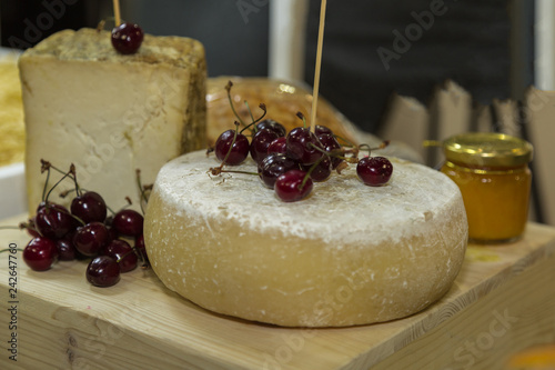 Round Shape of Fresh Cheese with Delicious Red Cherries on Top